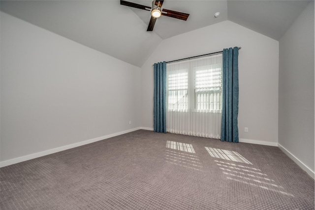 spare room featuring baseboards, lofted ceiling, carpet, and ceiling fan