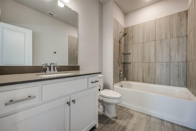 full bath featuring bathtub / shower combination, toilet, vanity, and visible vents