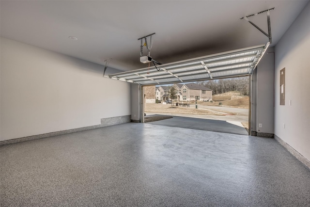 garage with a garage door opener and baseboards