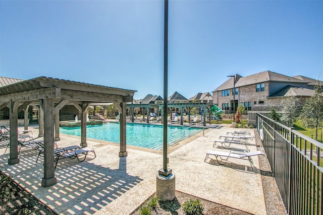 pool featuring a patio area and fence