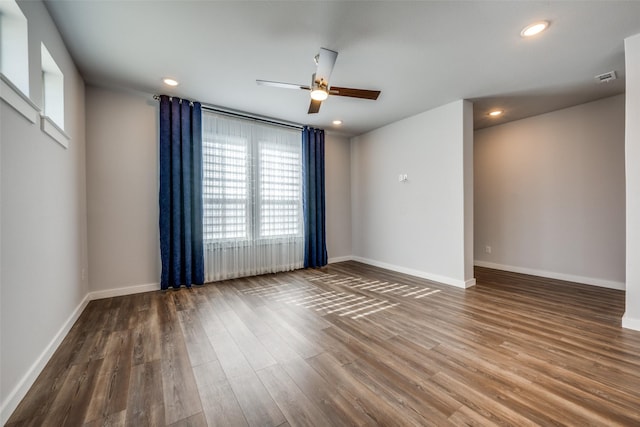 empty room featuring recessed lighting, baseboards, wood finished floors, and a ceiling fan