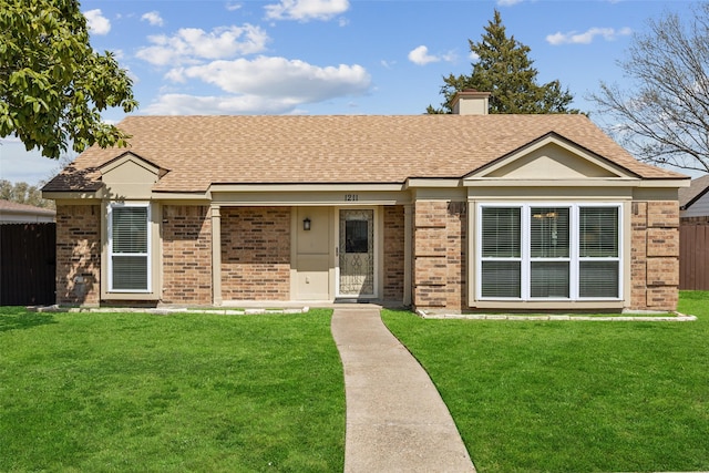 ranch-style home featuring brick siding, a front lawn, and fence