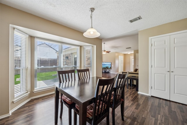 dining room featuring visible vents, baseboards, a textured ceiling, and dark wood-style flooring