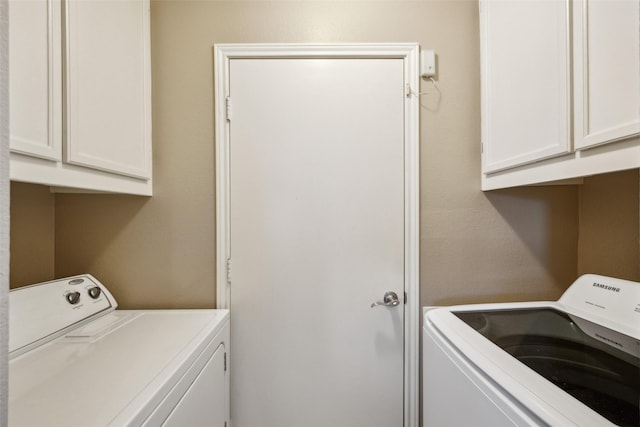 laundry area featuring cabinet space and washer and clothes dryer