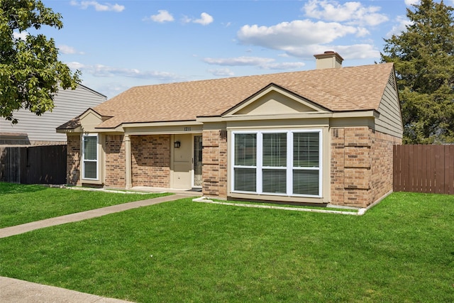 ranch-style home with brick siding, a front yard, and fence