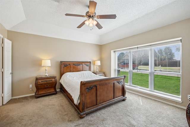 bedroom featuring a textured ceiling, a ceiling fan, baseboards, and light carpet