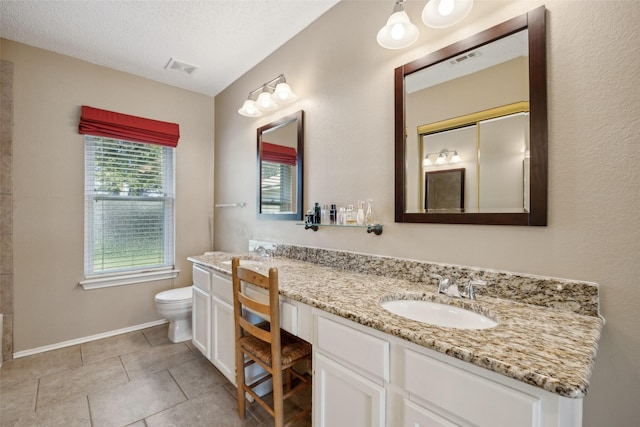 full bathroom featuring visible vents, toilet, a sink, tile patterned flooring, and double vanity