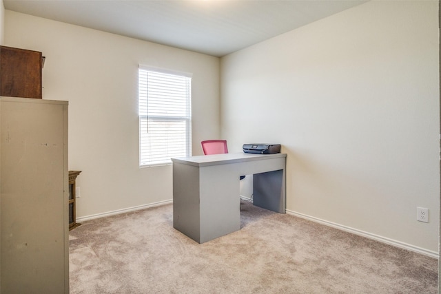 carpeted office featuring baseboards