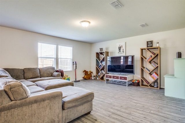 living area with visible vents and light wood finished floors