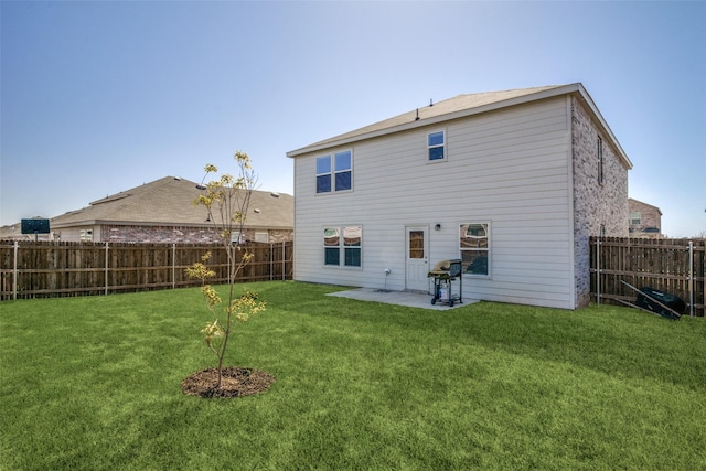 back of property featuring a patio, a yard, and a fenced backyard