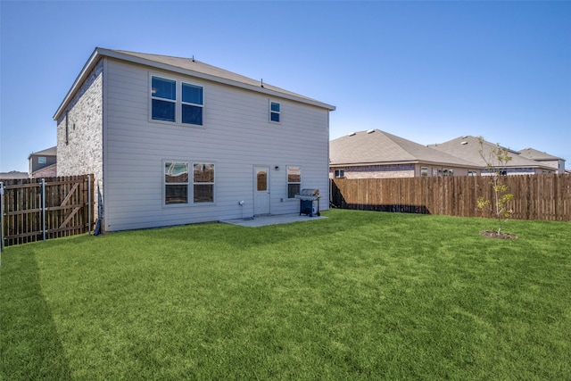 back of house featuring a fenced backyard, a patio area, and a yard