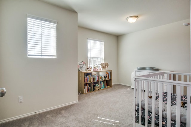 bedroom with baseboards, multiple windows, and carpet