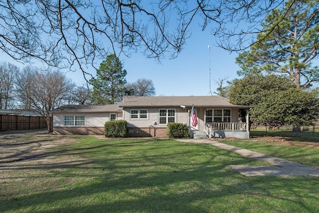 ranch-style house with a front lawn, fence, and covered porch