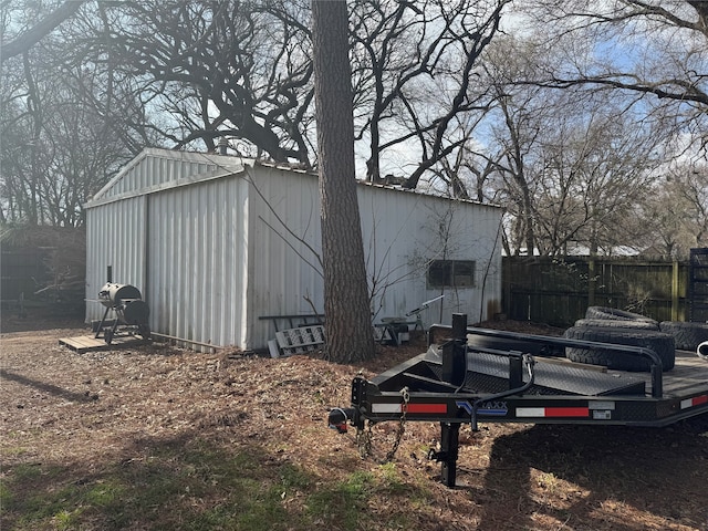 view of outbuilding with an outdoor structure and fence