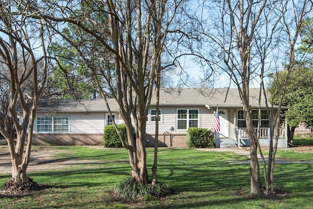 ranch-style home with brick siding and a front yard