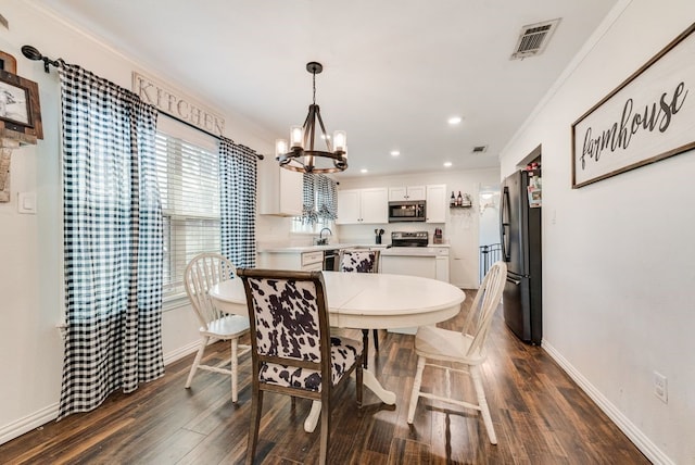 dining space with visible vents, baseboards, dark wood-type flooring, and an inviting chandelier