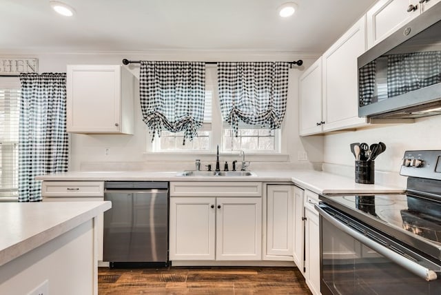 kitchen with white cabinets, stainless steel appliances, and a sink