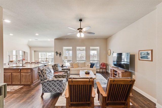 living area featuring recessed lighting, baseboards, dark wood-style flooring, and a ceiling fan