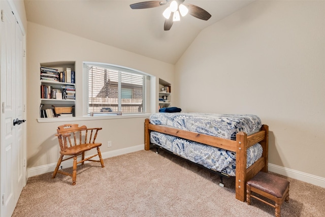 carpeted bedroom featuring baseboards, lofted ceiling, and a ceiling fan