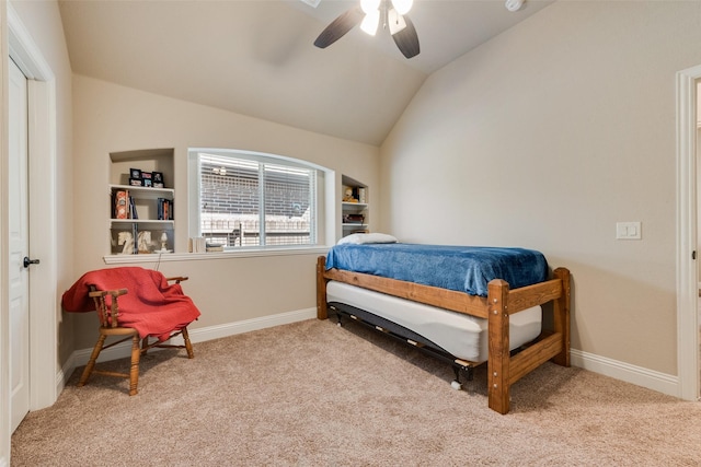 carpeted bedroom featuring baseboards, lofted ceiling, and a ceiling fan