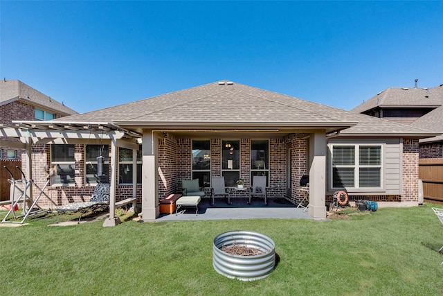 rear view of house with a yard, brick siding, a pergola, and a shingled roof