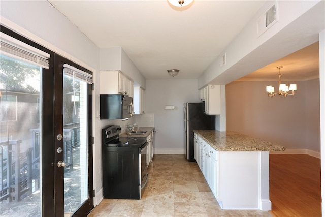 kitchen with visible vents, range with electric cooktop, black microwave, and white cabinetry