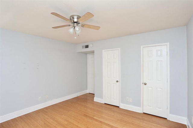 unfurnished bedroom featuring visible vents, baseboards, light wood-style floors, and a ceiling fan