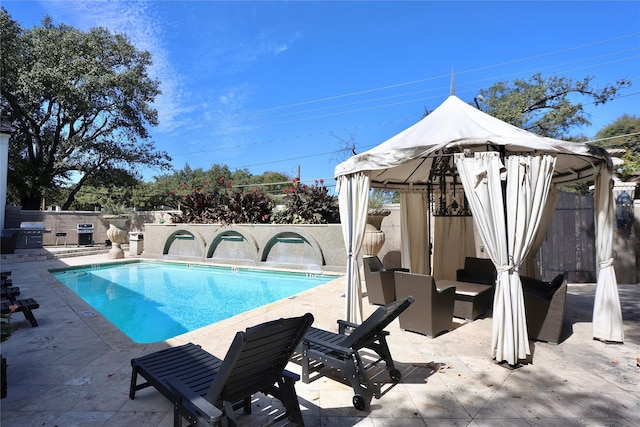 view of swimming pool with a fenced backyard, a gazebo, a grill, a fenced in pool, and a patio area