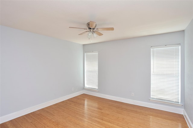 unfurnished room featuring ceiling fan, baseboards, and light wood-style flooring