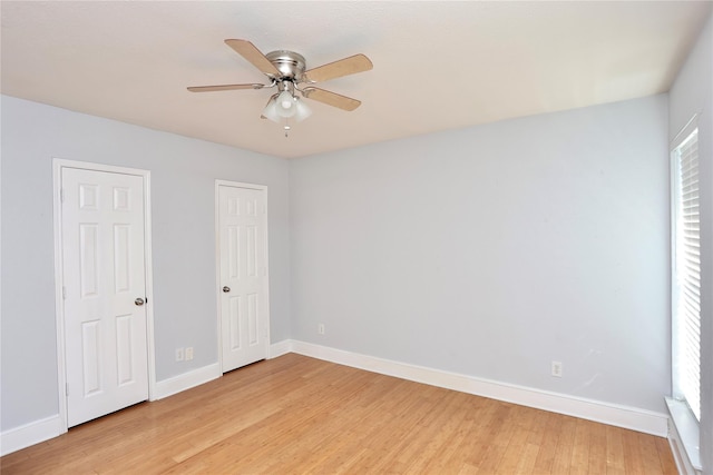 unfurnished bedroom featuring light wood-style flooring, baseboards, and ceiling fan