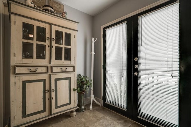 doorway to outside featuring french doors and baseboards