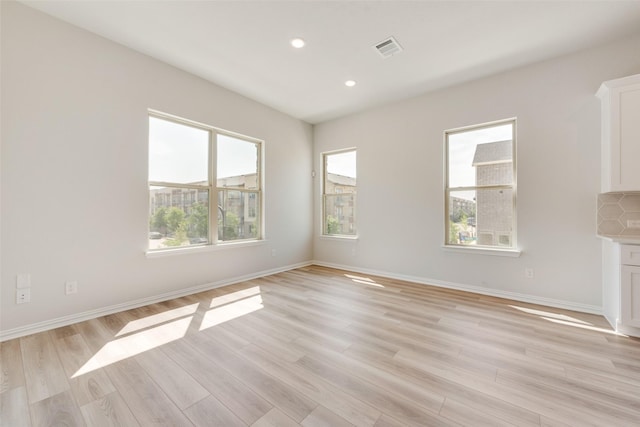 4301 Ruth Rd, North Richland Hills, TX 76180 - unfurnished room featuring a wealth of natural light, light wood-style floors, visible vents, and recessed lighting