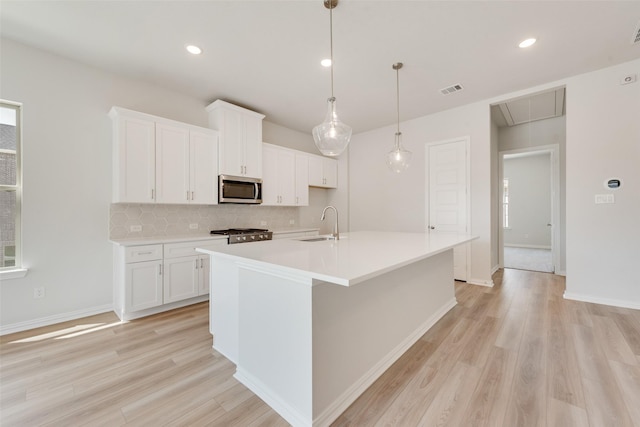 4301 Ruth Rd, North Richland Hills, TX 76180 - kitchen featuring stainless steel microwave, backsplash, light wood-style flooring, and stove