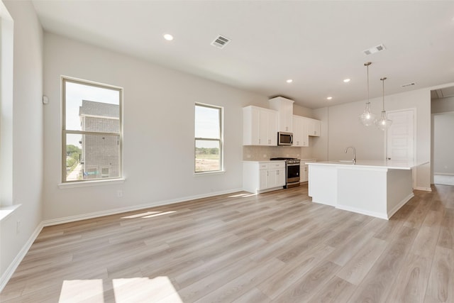 4301 Ruth Rd, North Richland Hills, TX 76180 - kitchen featuring white cabinets, light wood-type flooring, visible vents, and stainless steel appliances