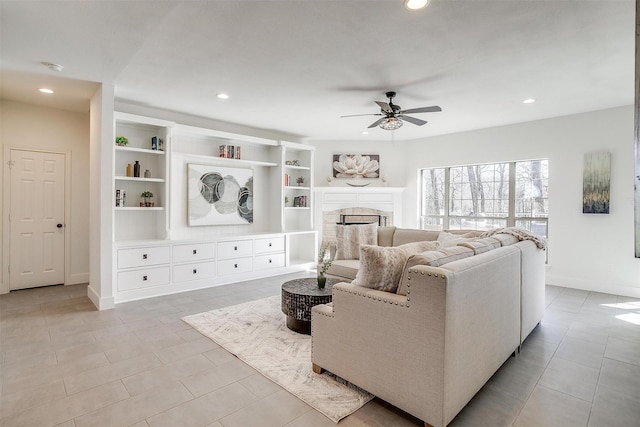 living area featuring recessed lighting, a fireplace, and a ceiling fan