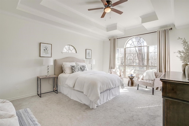 bedroom featuring baseboards, a raised ceiling, light carpet, and ornamental molding