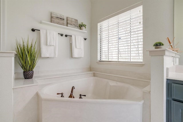 full bathroom with vanity and a garden tub