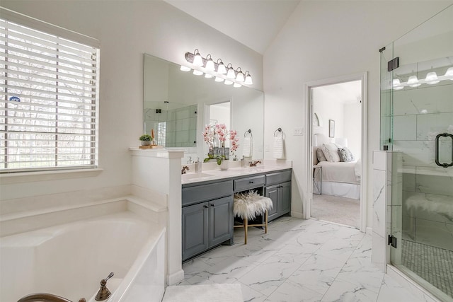 ensuite bathroom featuring a stall shower, marble finish floor, ensuite bath, and vaulted ceiling