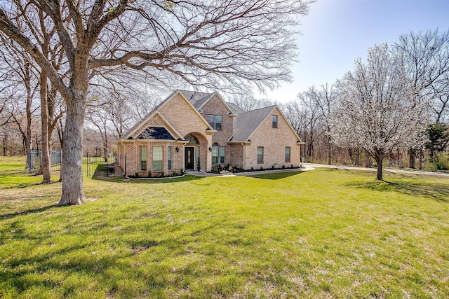 view of front of home featuring a front yard and brick siding