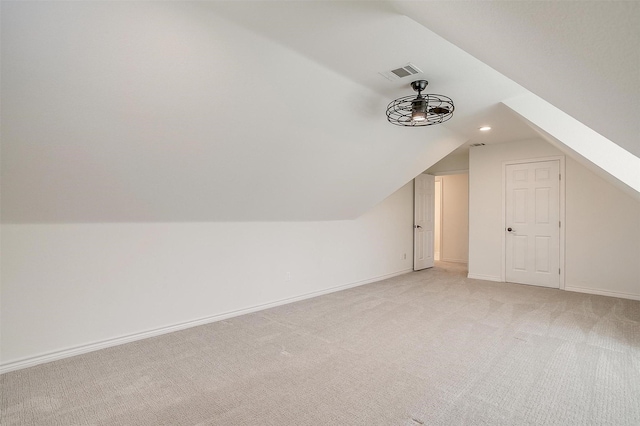 bonus room featuring light carpet, visible vents, lofted ceiling, and baseboards