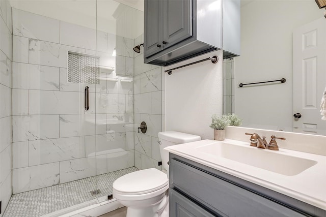 full bath featuring vanity, a shower stall, and toilet