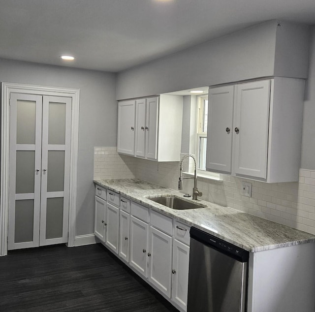 kitchen featuring dark wood-style floors, white cabinets, dishwasher, and a sink