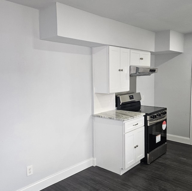 kitchen with under cabinet range hood, electric range, dark wood finished floors, and white cabinets