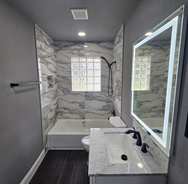 full bath with visible vents, toilet, wood finished floors, shower / bath combination, and vanity