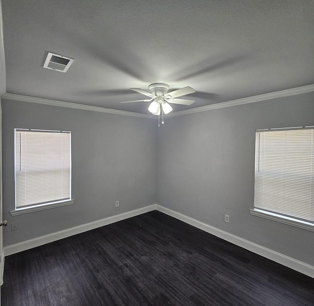 unfurnished room featuring visible vents, crown molding, baseboards, dark wood-type flooring, and a ceiling fan