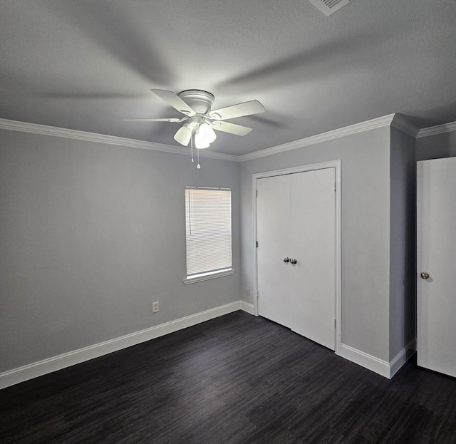 unfurnished bedroom featuring dark wood finished floors, baseboards, and ornamental molding