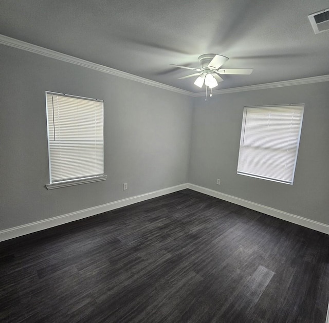 unfurnished room with crown molding, a ceiling fan, visible vents, and dark wood-type flooring