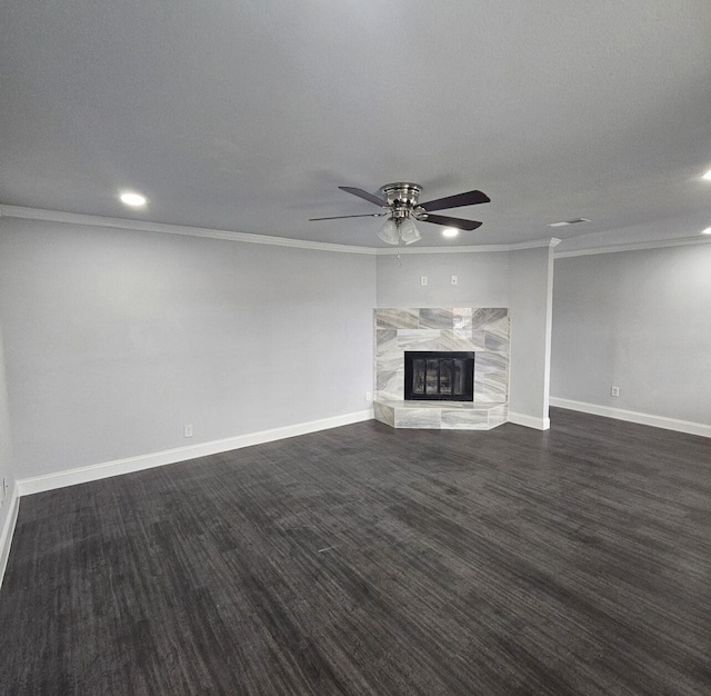 unfurnished living room featuring ornamental molding, a ceiling fan, a fireplace, baseboards, and dark wood-style flooring