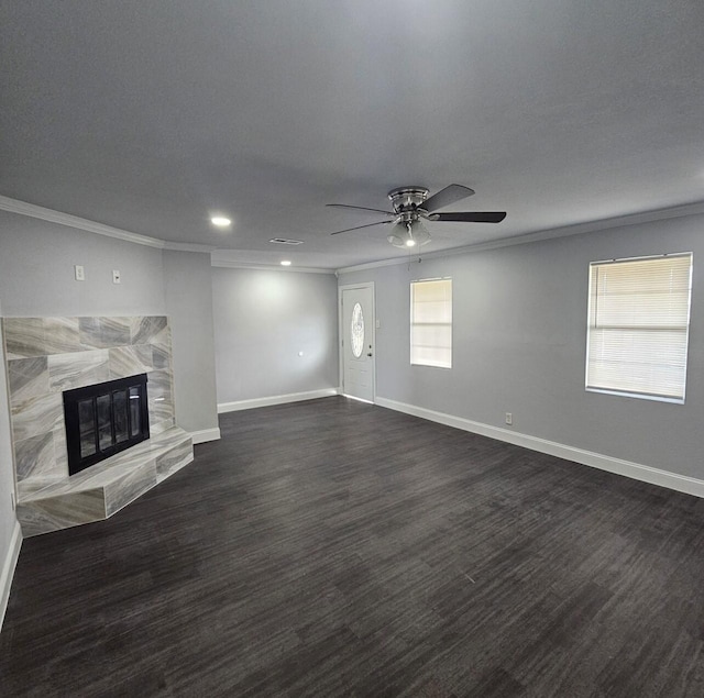 unfurnished living room featuring dark wood finished floors, baseboards, a ceiling fan, and ornamental molding