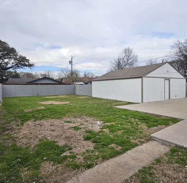 view of yard with an outbuilding, an outdoor structure, and fence